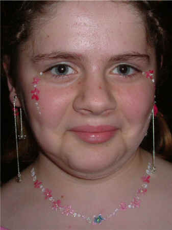 Face Painting: Adult female with pink and white necklace and matching eye makeup co-ordinating with subjects own earings.